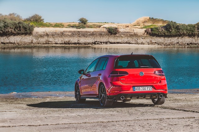 the back of a red VW Golf GTI in front of a lake